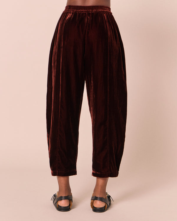 model wears mabel umber velvet trousers back