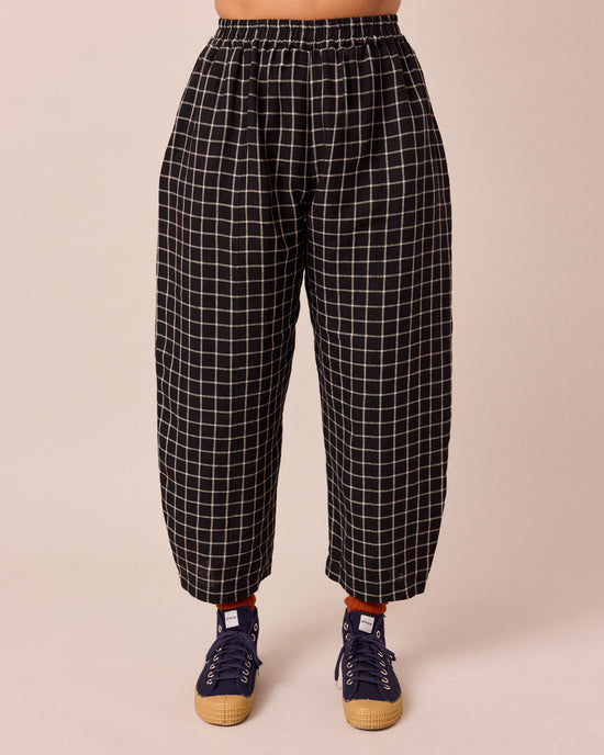 model wears mabel black grid linen trousers front