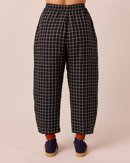 model wears mabel black grid linen trousers back