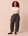 model wears mabel black mini grid linen trousers right