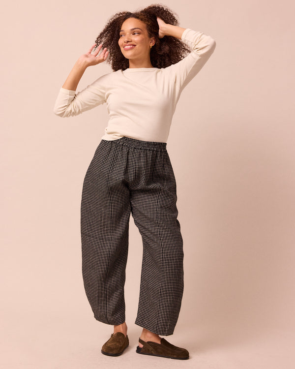 model wears mabel black mini grid linen trousers