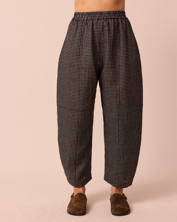 model wears mabel black mini grid linen trousers front