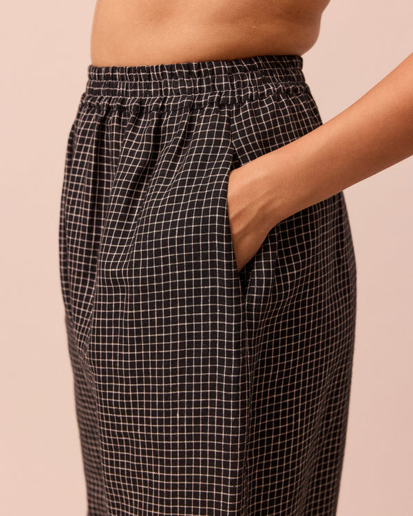 model wears mabel black mini grid linen trousers