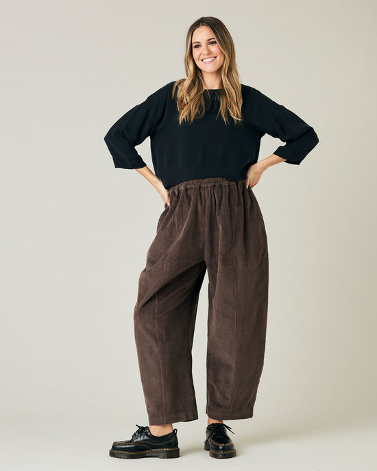 pregnant model wears brown cord mabel trousers