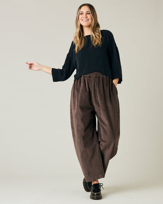 pregnant model wears brown cord mabel trousers