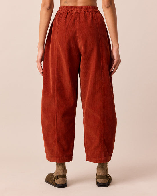 model wears mabel burnt orange cord trousers back