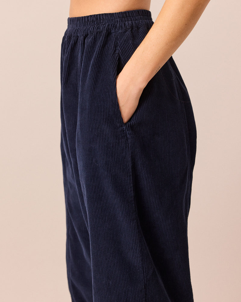 model wears mabel navy cord trousers left