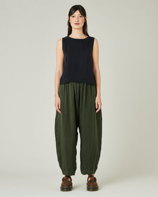 model wears dark khaki cupro mabel trousers