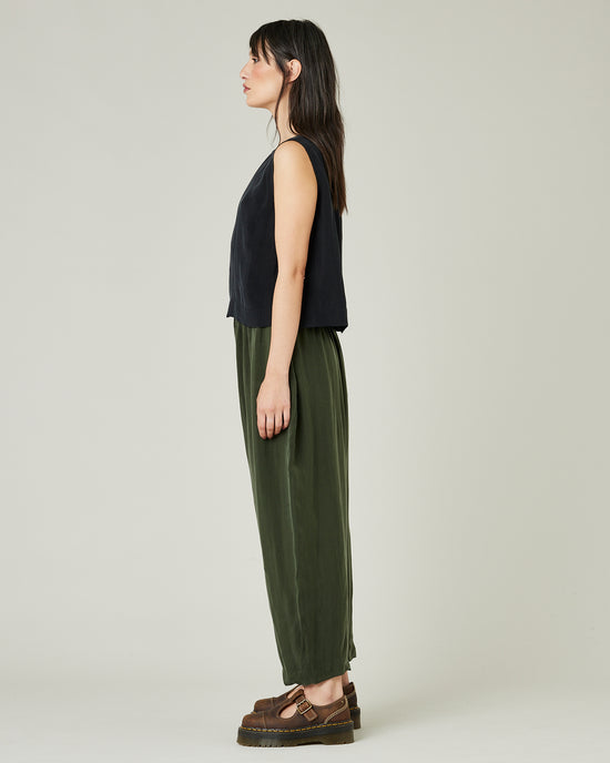 model wears dark khaki cupro mabel trousers