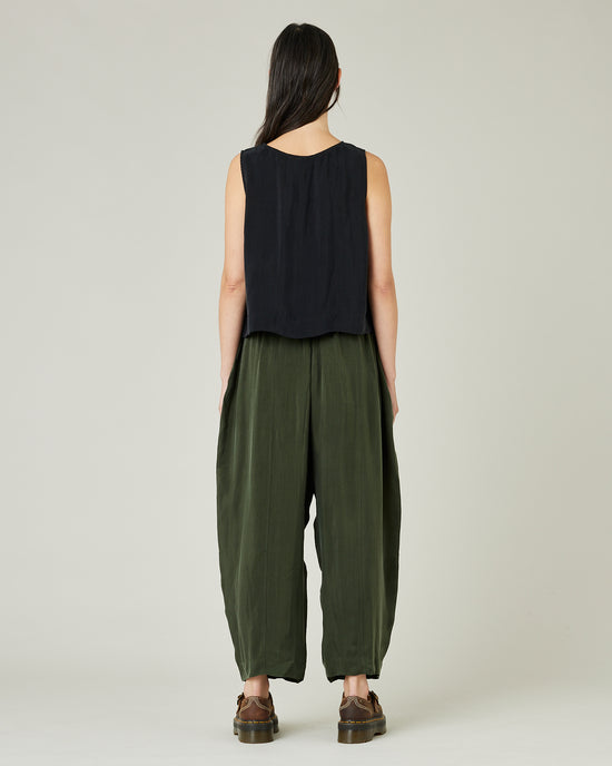 model wears dark khaki cupro mabel trousers