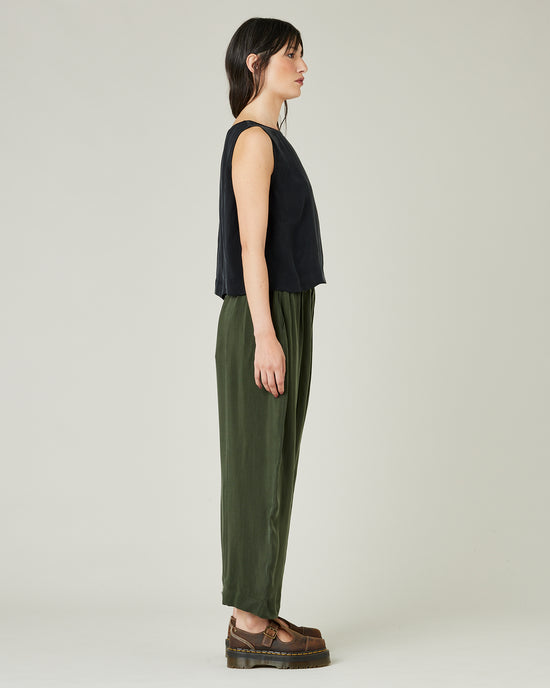 model wears dark khaki cupro mabel trousers