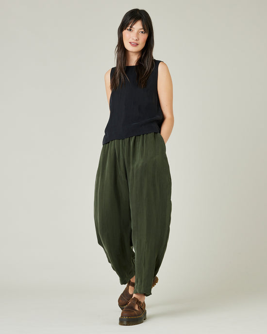 model wears dark khaki cupro mabel trousers