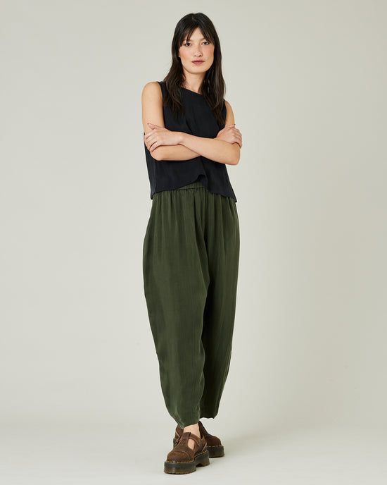 model wears dark khaki cupro mabel trousers