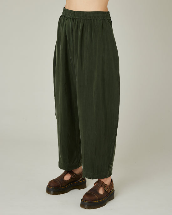 model wears dark khaki cupro mabel trousers