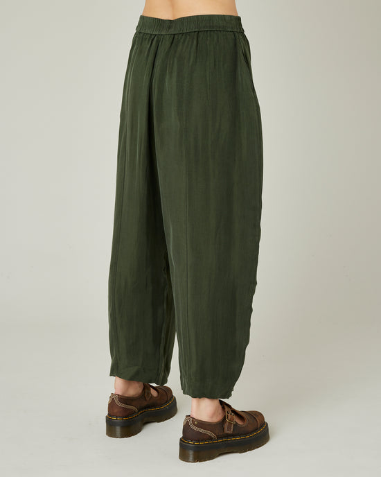 model wears dark khaki cupro mabel trousers