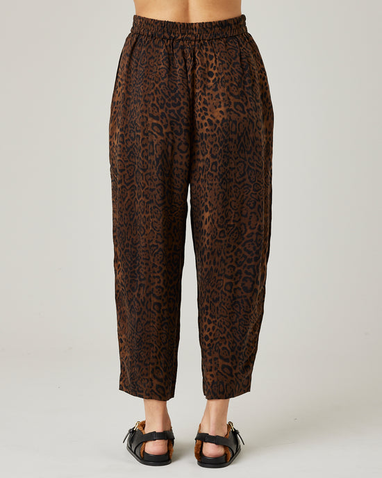 model wears mabel cupro trousers in dark leopard 