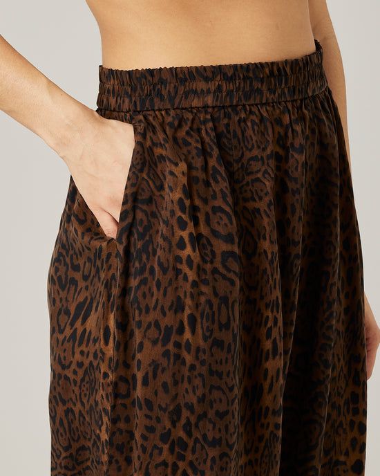 model wears mabel cupro trousers in dark leopard 