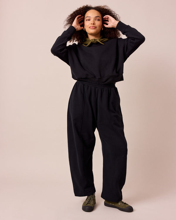 model wears mabel black fleeceback jersey trousers right