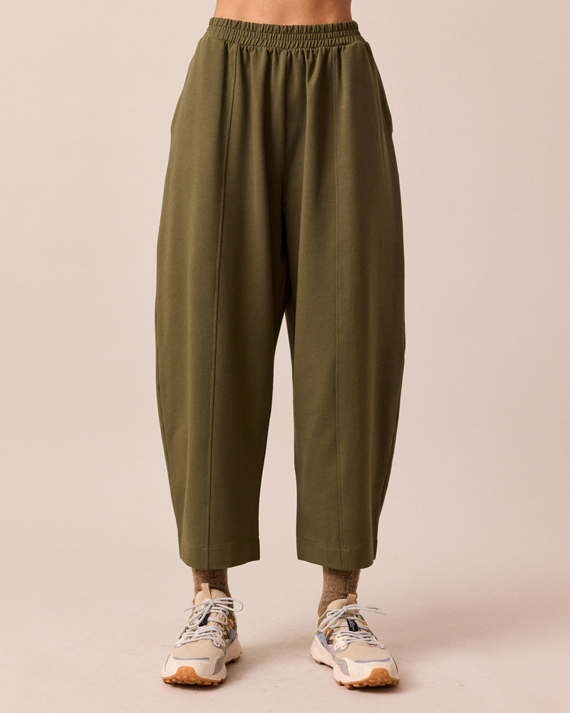 model wears mabel light olive jersey trousers front