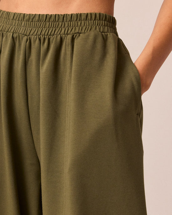 model wears mabel light olive jersey trousers