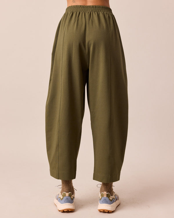 model wears mabel light olive jersey trousers back