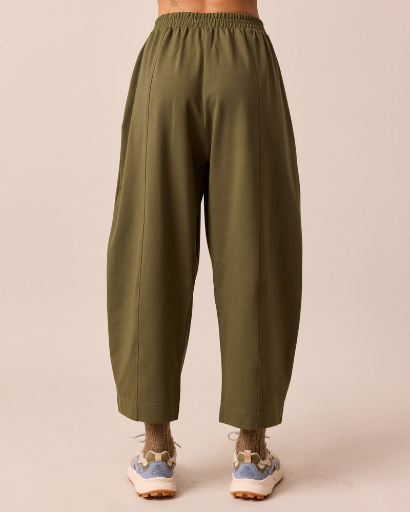 model wears mabel light olive jersey trousers back