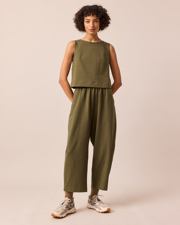 model wears mabel light olive jersey trousers left