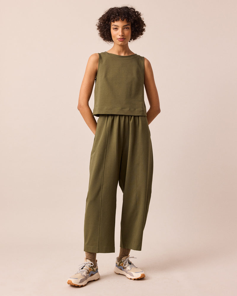 model wears mabel light olive jersey trousers left