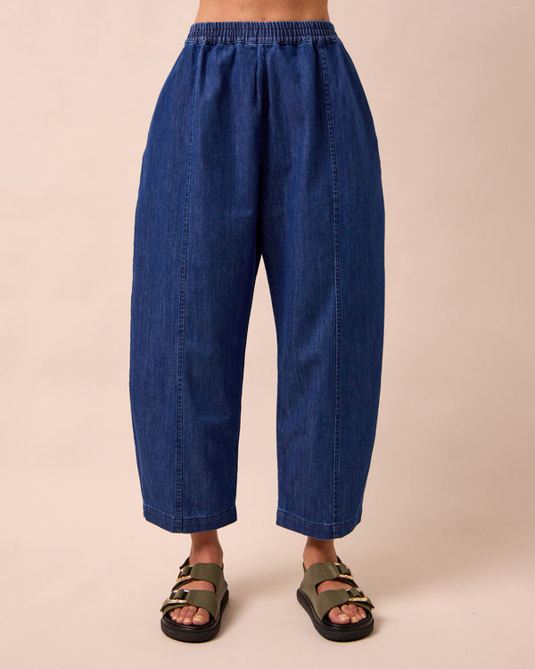 model wears mabel mid blue light denim trousers front