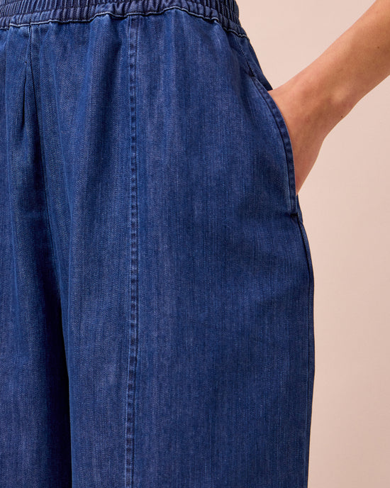 model wears mabel mid blue light denim trousers