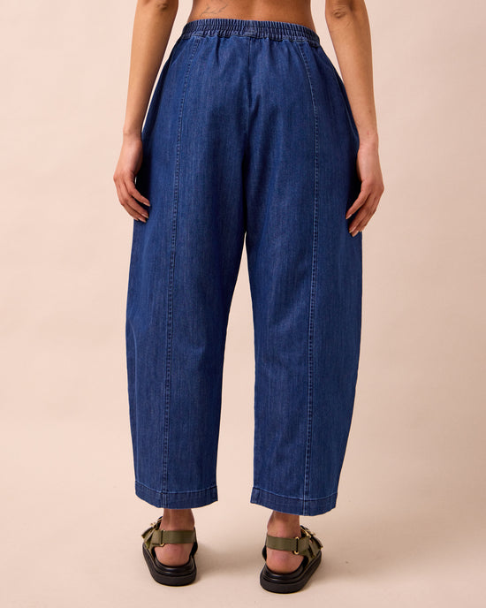 model wears mabel mid blue light denim trousers back