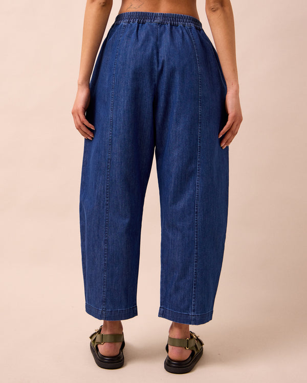 model wears mabel mid blue light denim trousers back