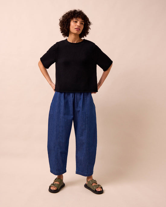 model wears mabel mid blue light denim trousers right