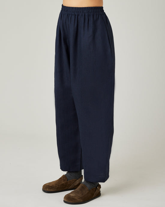 model wears navy linen mabel trousers left