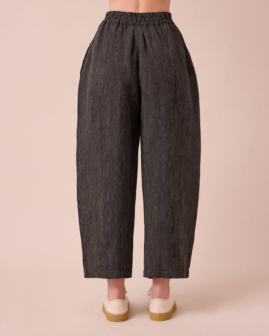 model wears mabel pencil stripe linen trousers back