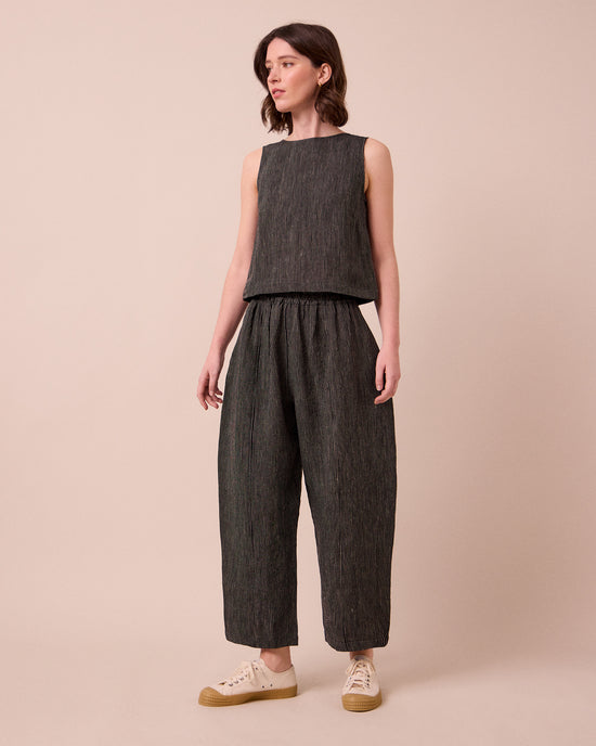 model wears mabel pencil stripe linen trousers left