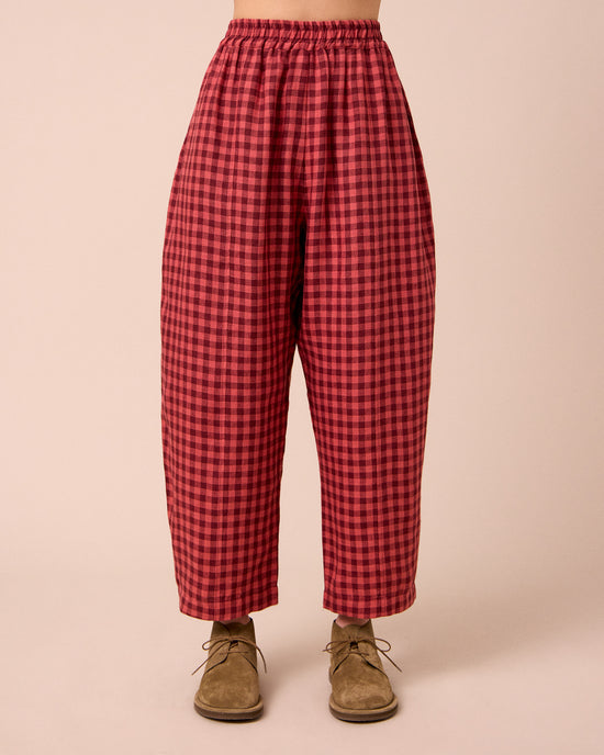 model wears mabel deep rose gingham linen trousers front