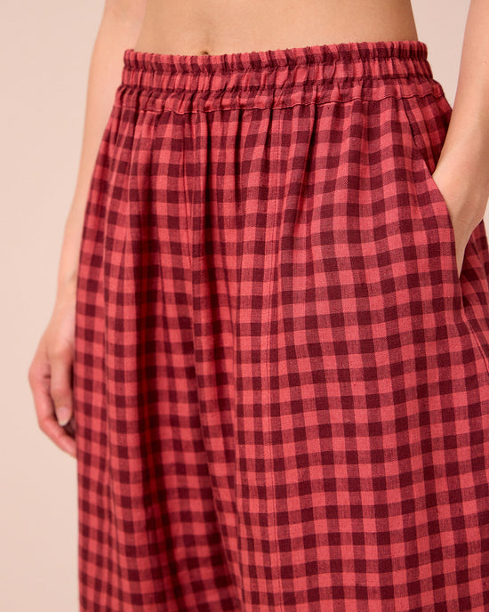 model wears mabel deep rose gingham linen trousers