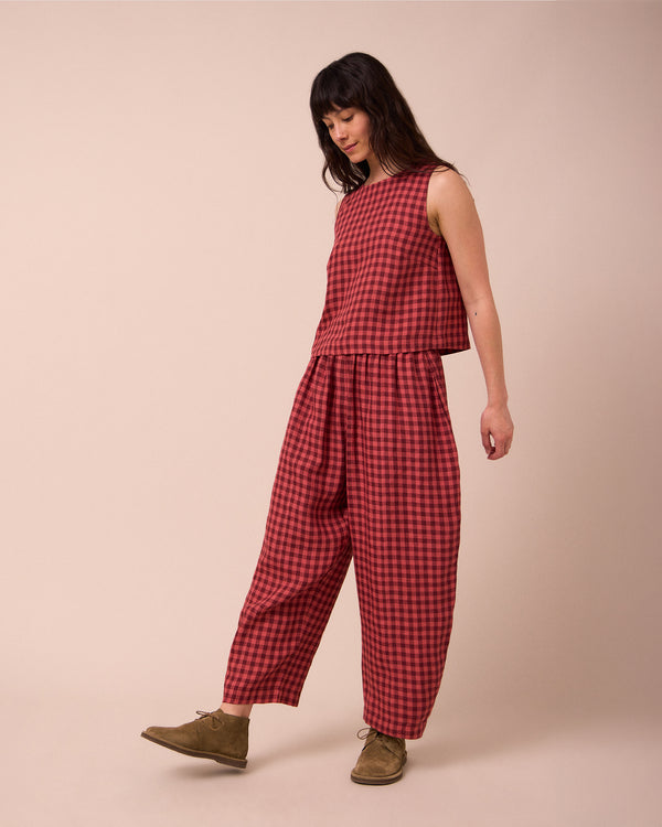 model wears mabel deep rose gingham linen trousers right