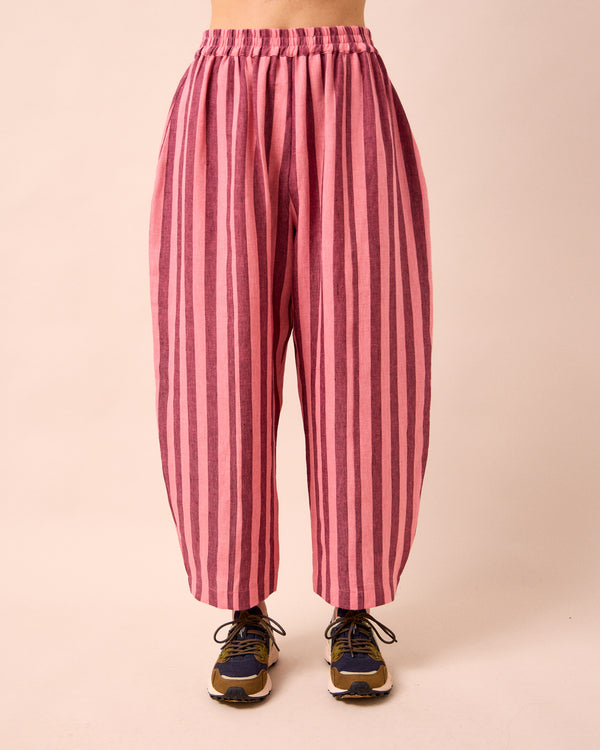 model wears mabel fiesta pink linen trousers front