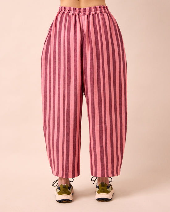 model wears mabel fiesta pink linen trousers back