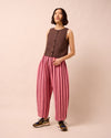 model wears mabel fiesta pink linen trousers left