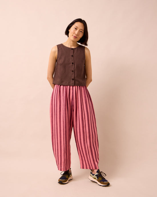 model wears mabel fiesta pink linen trousers right