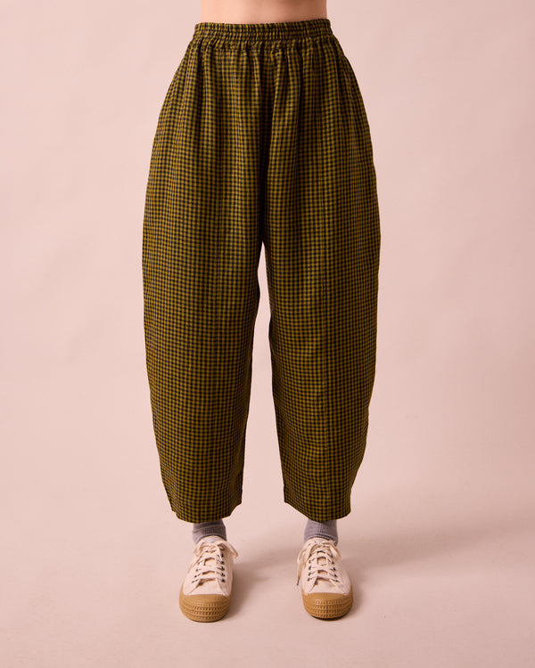 model wears mabel fresh olive mini gingham linen trousers front