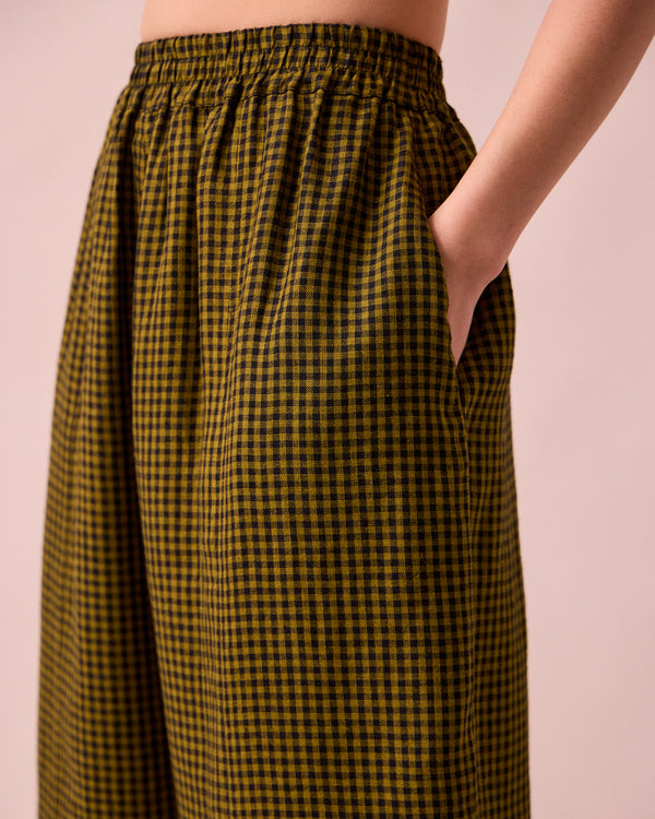model wears mabel fresh olive mini gingham linen trousers 
