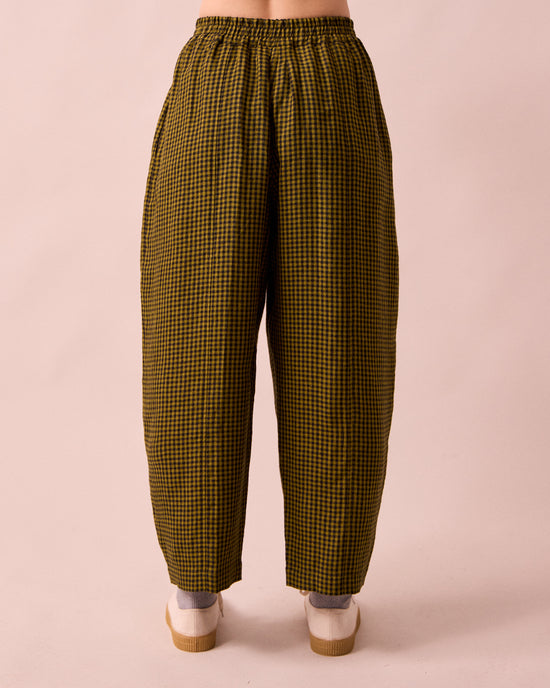 model wears mabel fresh olive mini gingham linen trousers back