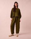 model wears mabel fresh olive mini gingham linen trousers left