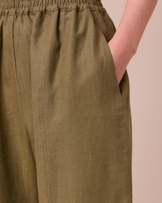 model wears mabel khaki linen trousers