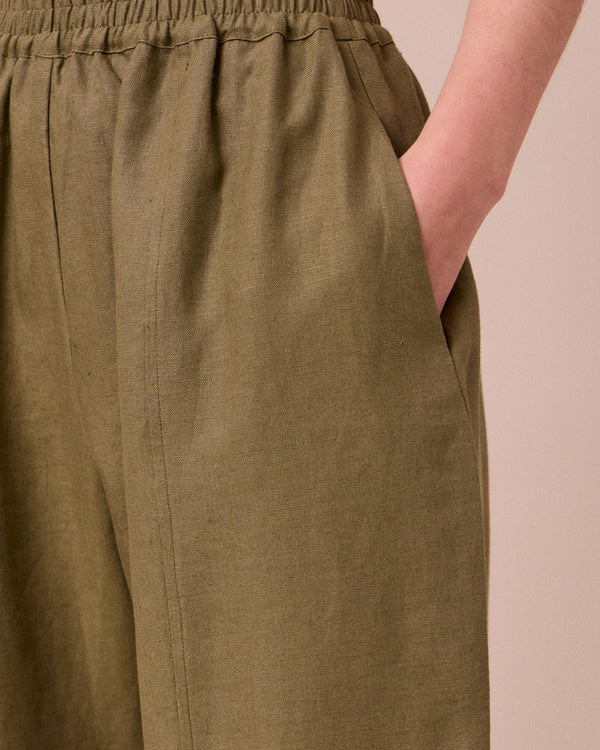 model wears mabel khaki linen trousers