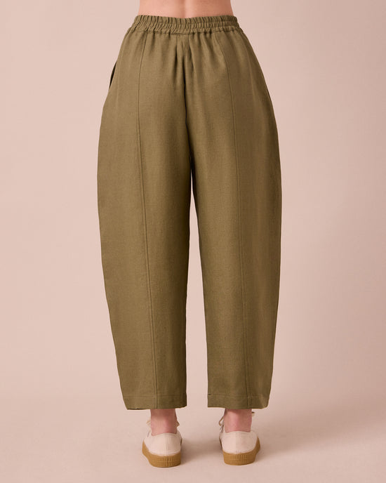 model wears mabel khaki linen trousers back